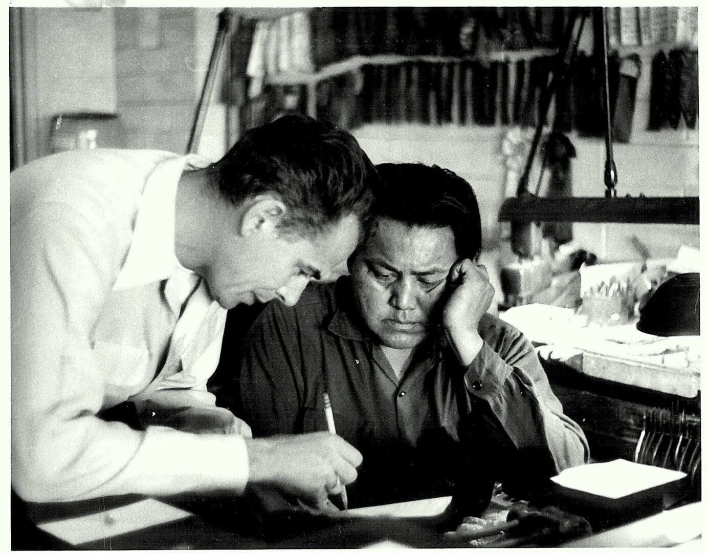 Two men collaborating at a desk.