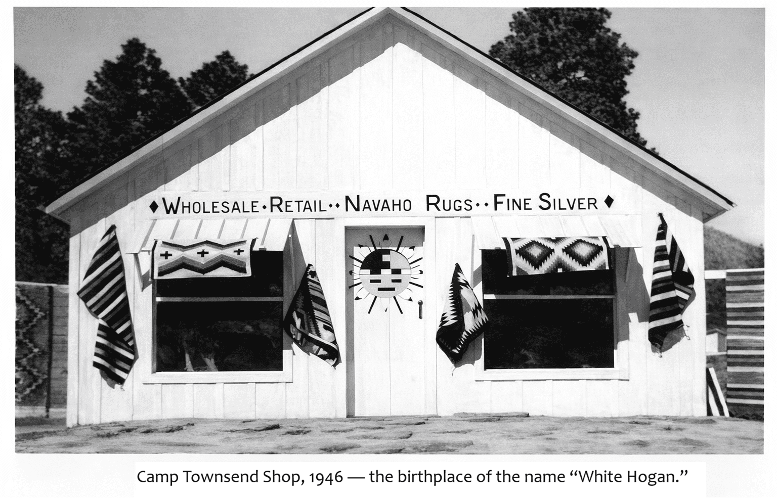 White wooden shop with Navajo rugs displayed.