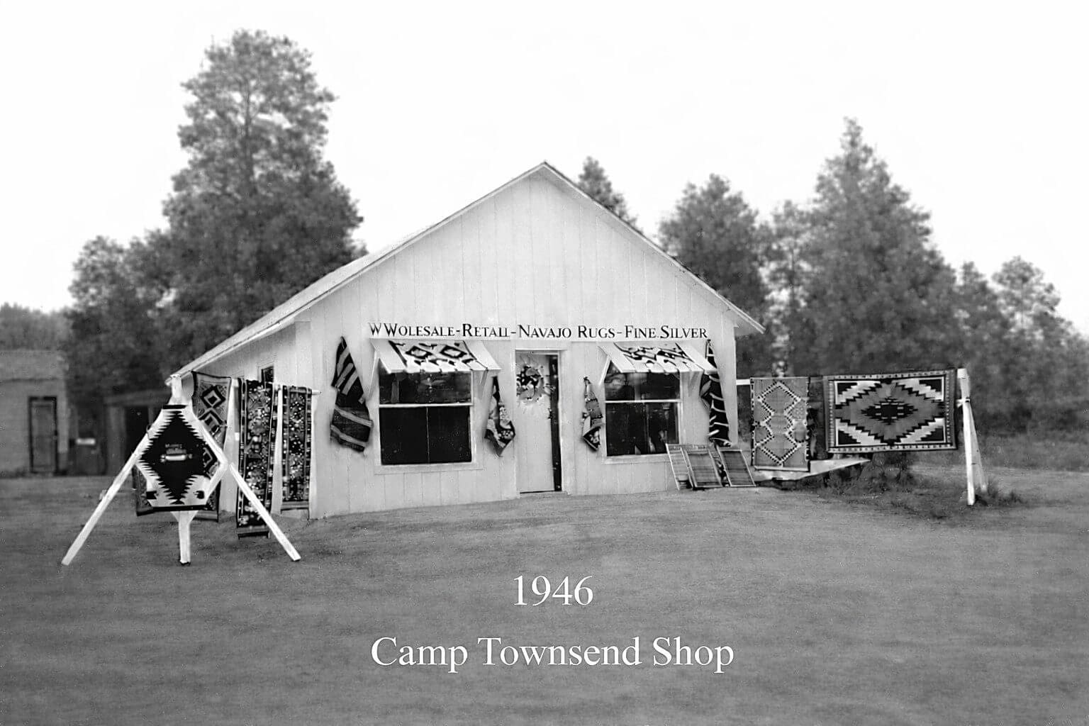 Historic shop with rugs displayed outside, 1946.