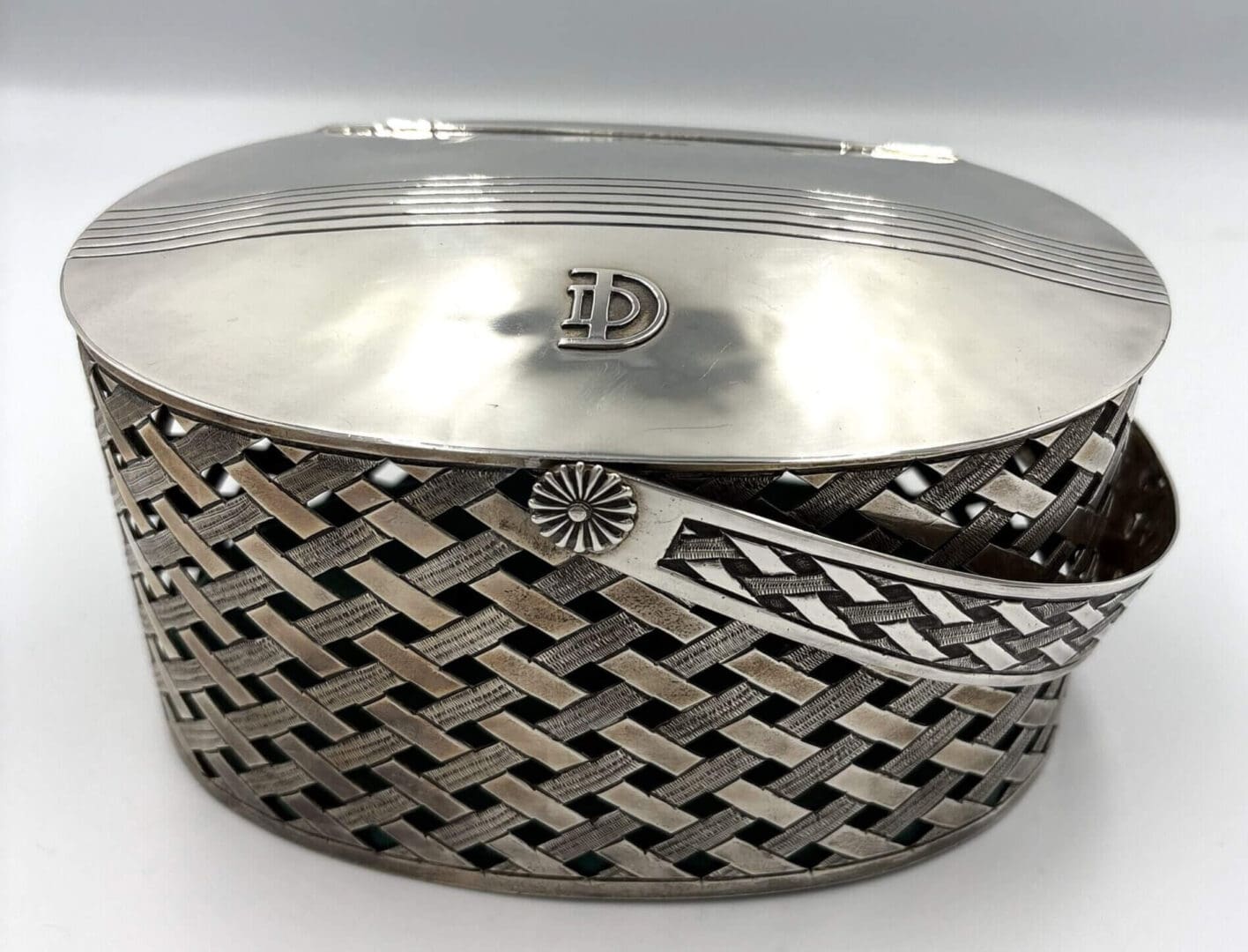 Silver oval basket with woven design.