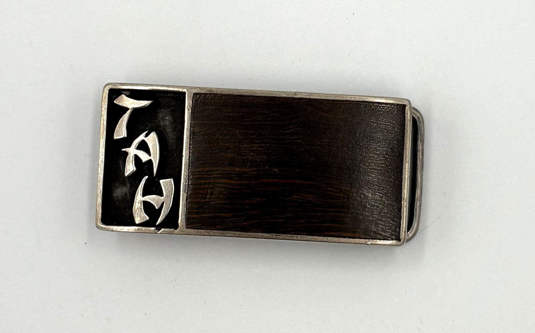 Silver and black engraved money clip.