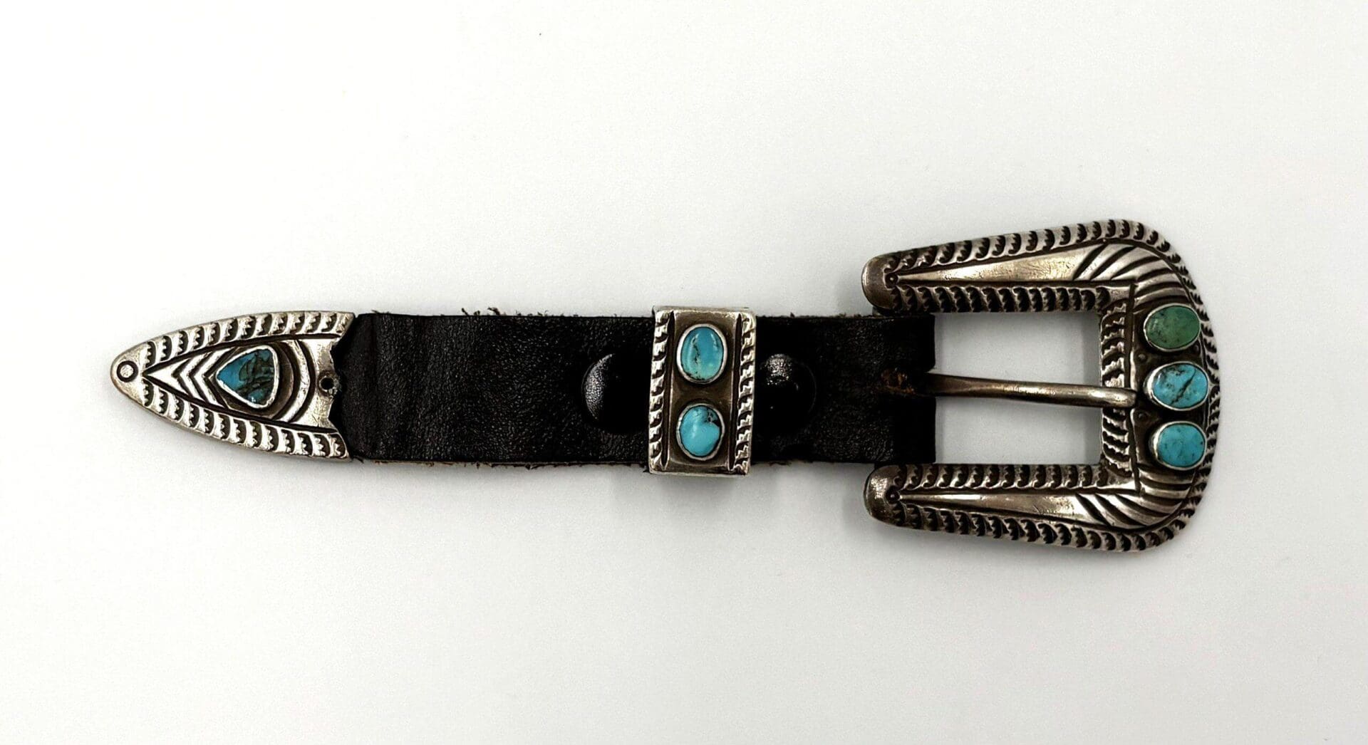 Silver belt buckle with turquoise stones.