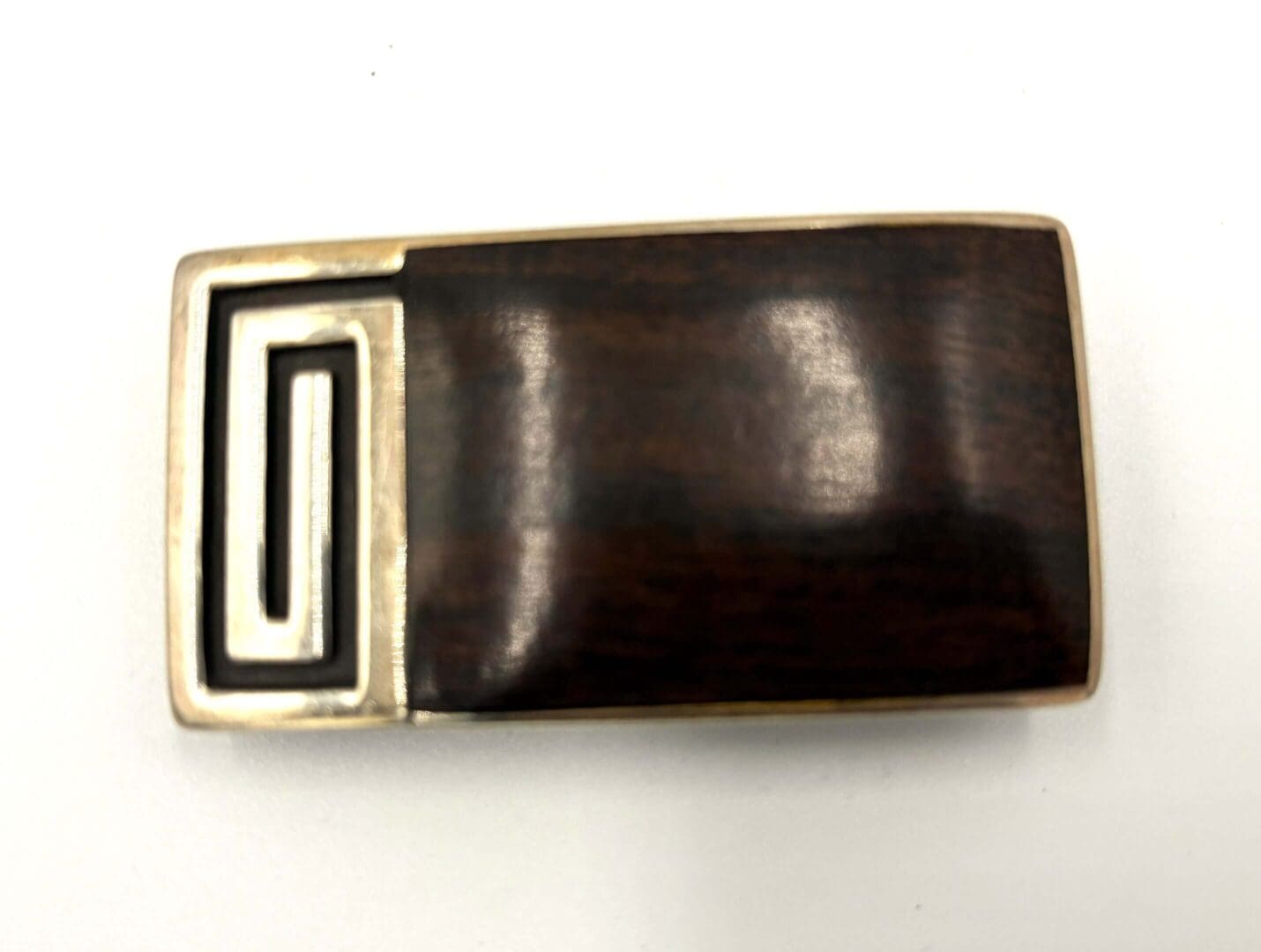 Rectangular wooden buckle with metal detailing.