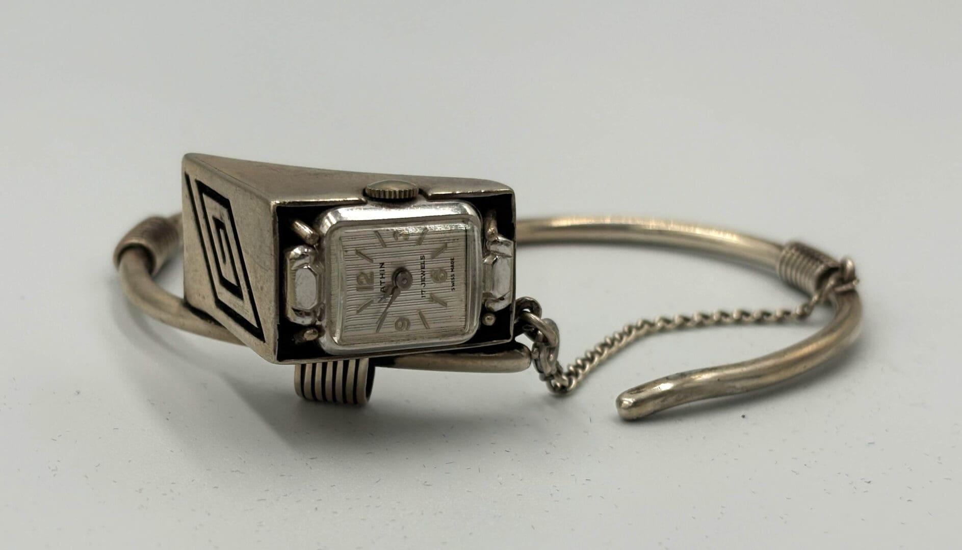 Vintage silver wristwatch with intricate design.