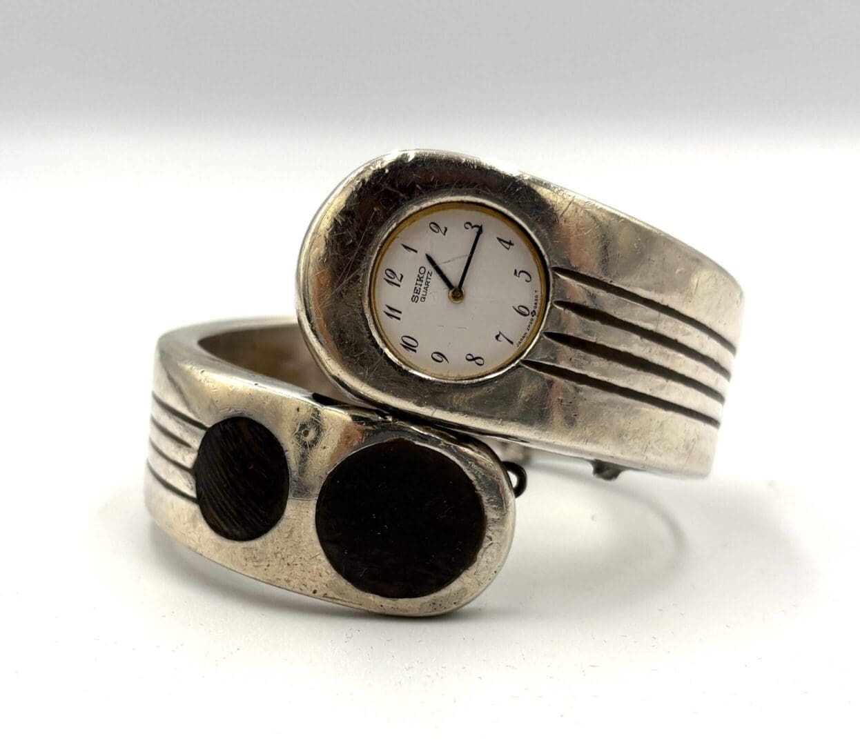 Silver bracelet watch with unique design.