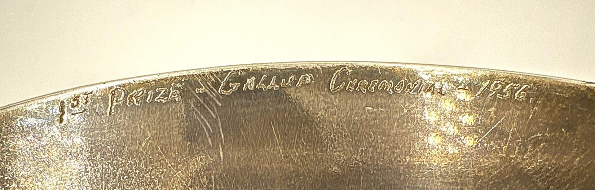 Engraved text on metal surface, close-up view.