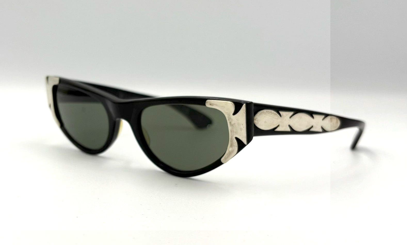 Black sunglasses with silver decorative accents.
