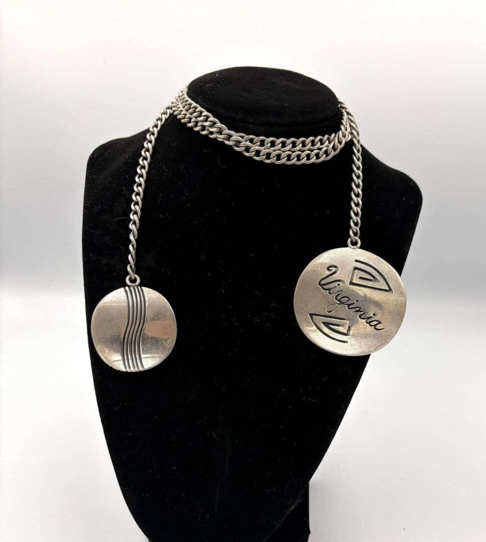 Silver necklace with round engraved pendants.