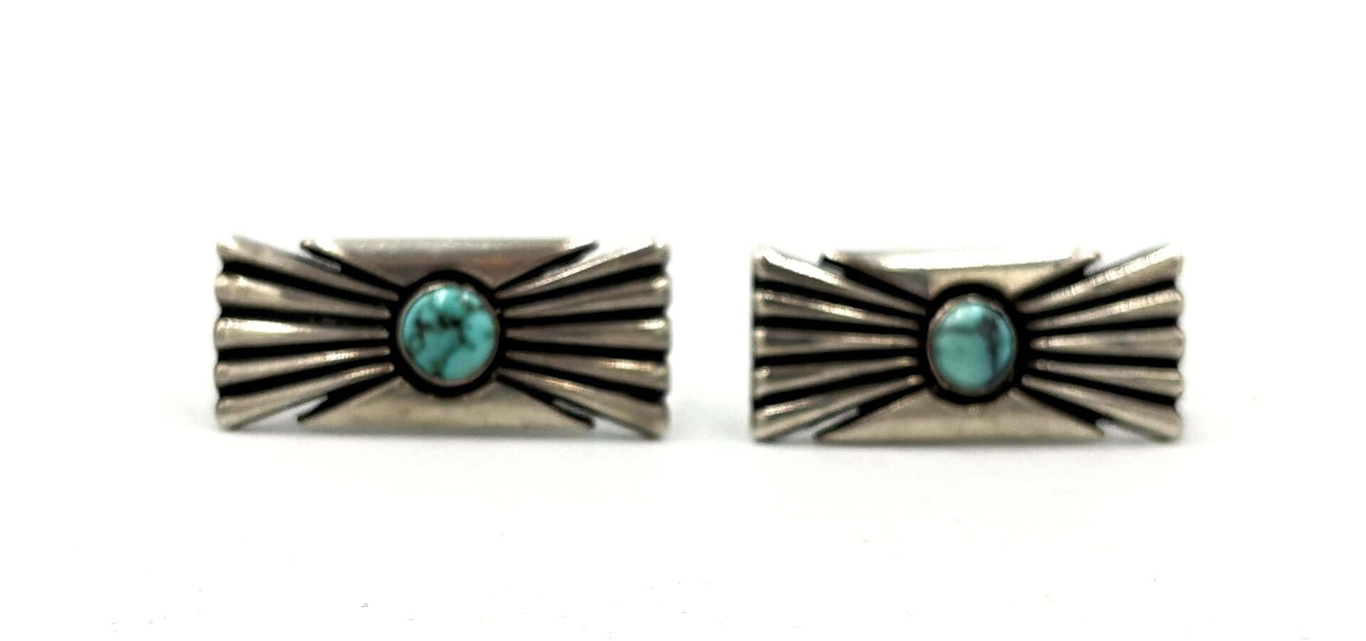 Silver earrings with turquoise stone design.