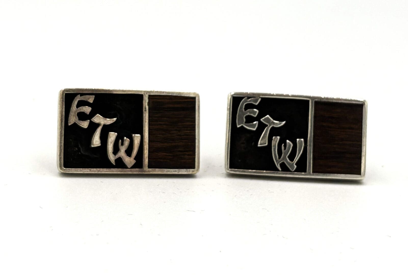 Rectangular cufflinks with "ETW" initials.
