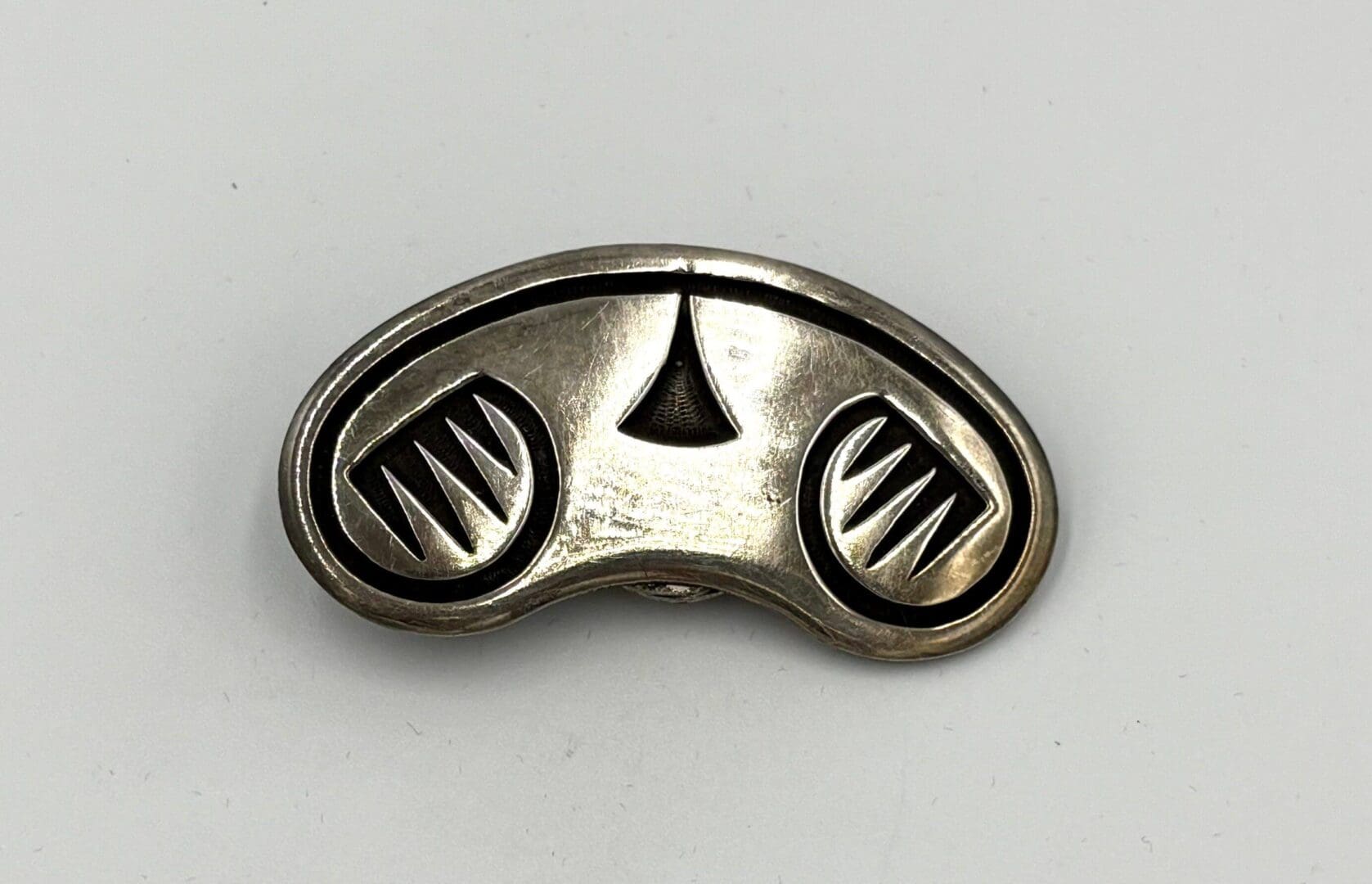 Silver vintage brooch with geometric design.