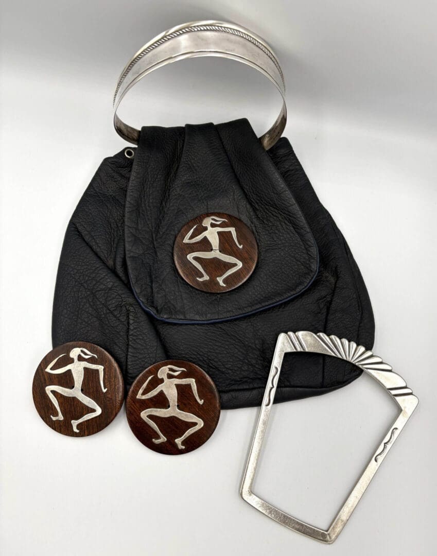 Leather bag with silver and wooden accessories.