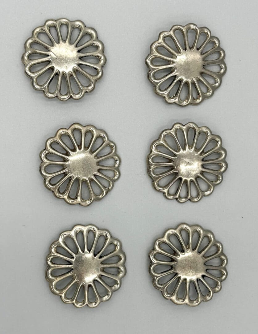 Six silver floral metal buttons arranged vertically.
