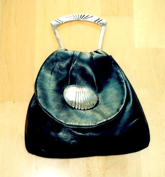 Vintage handbag with metal handle and clasp.