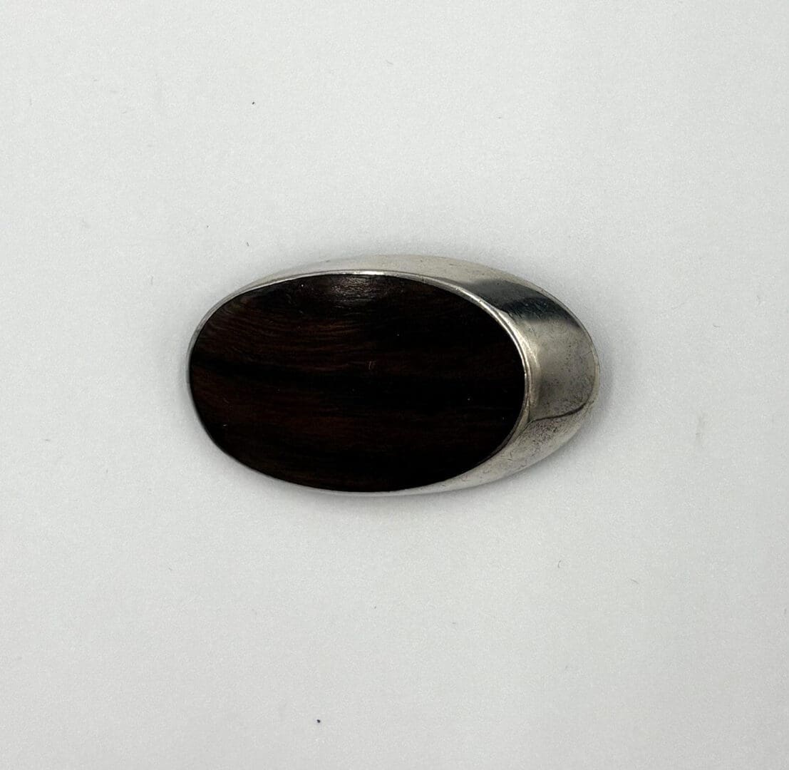 Silver and wood oval-shaped object.