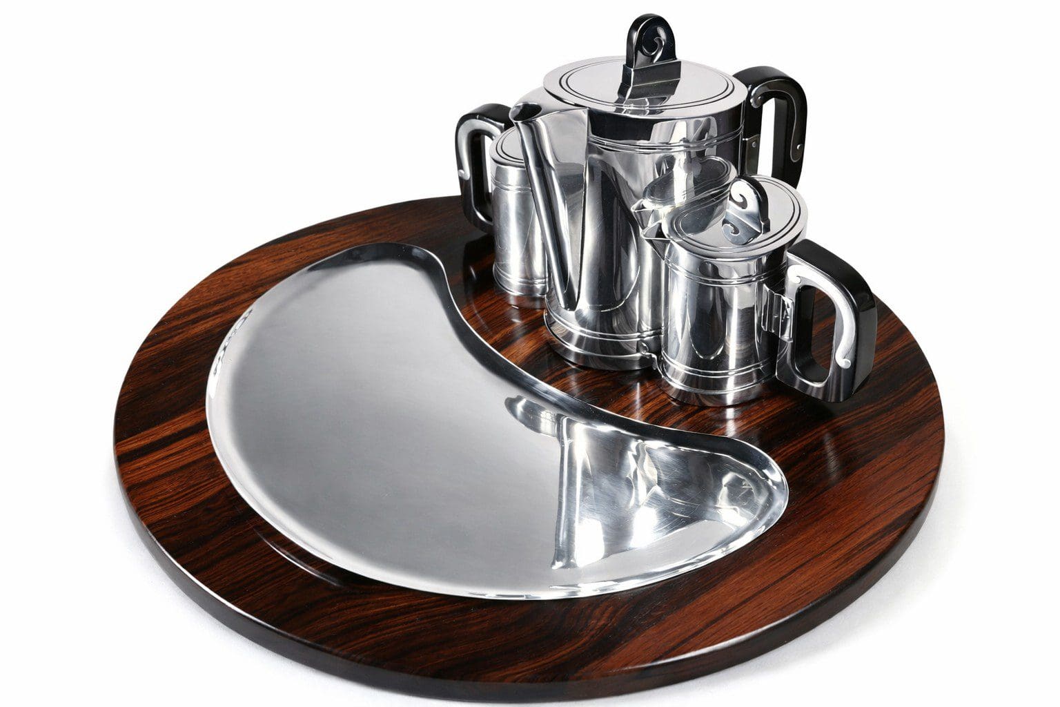 Silver tea set on wooden tray.