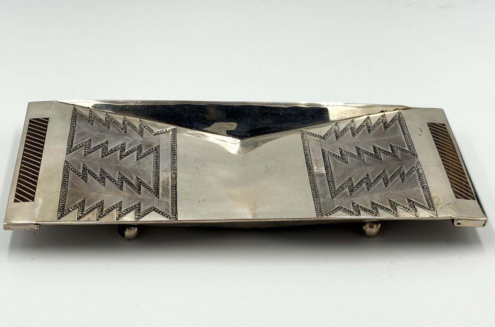Rectangular silver tray with geometric patterns.