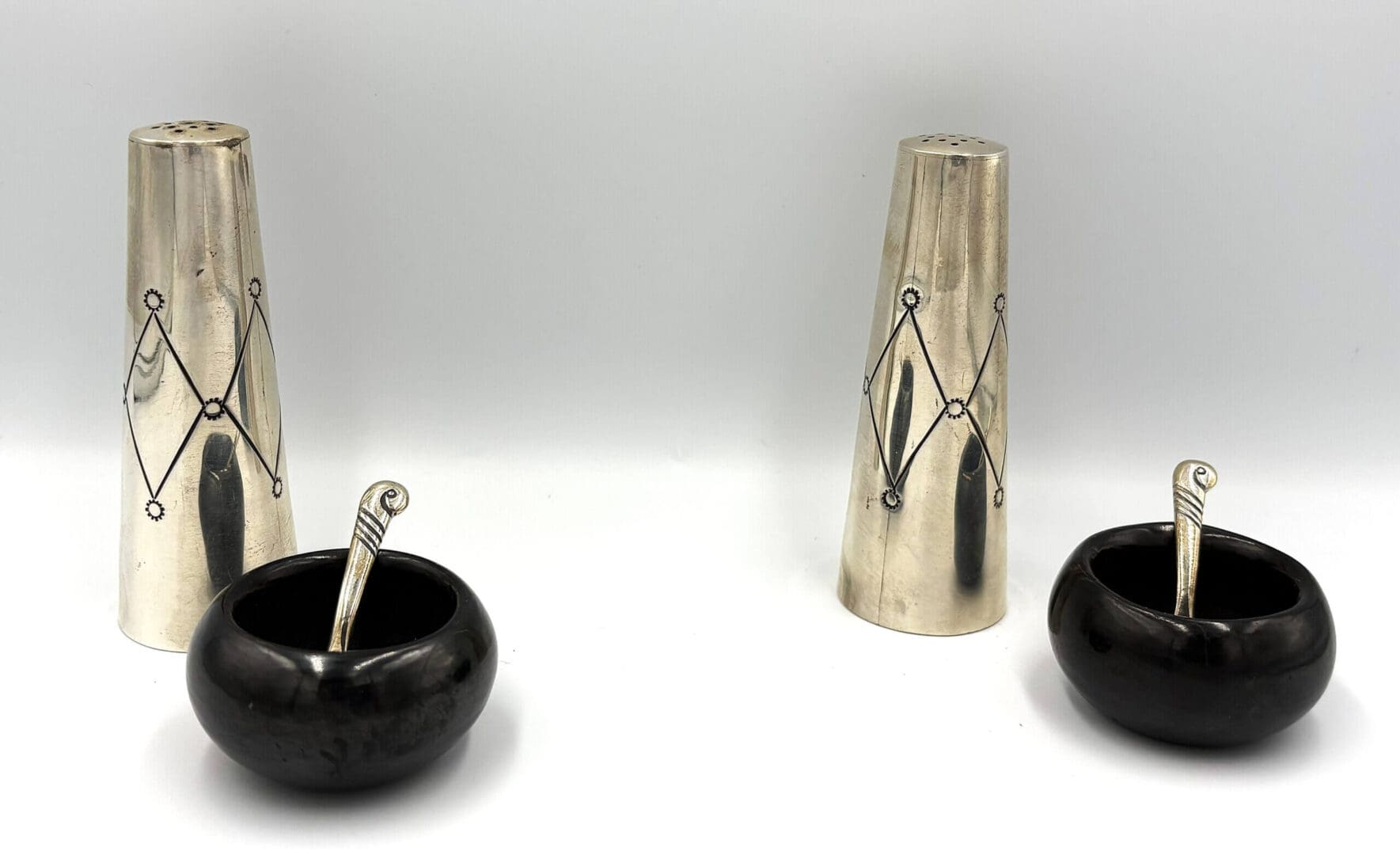 Silver cones with black bowls and spoons.