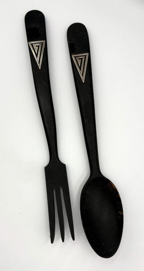 Black spoon and fork with triangular design.