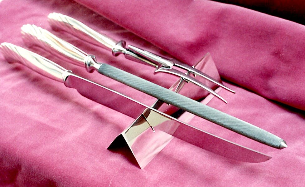 Carving set on magenta fabric background.