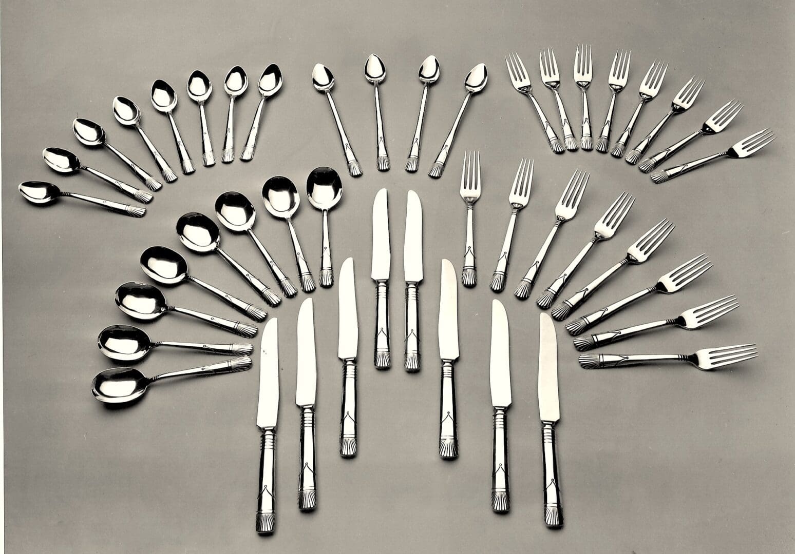Silverware set arranged in a symmetrical pattern.