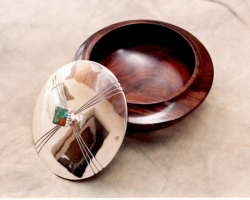 Wooden bowl with decorative metal lid.
