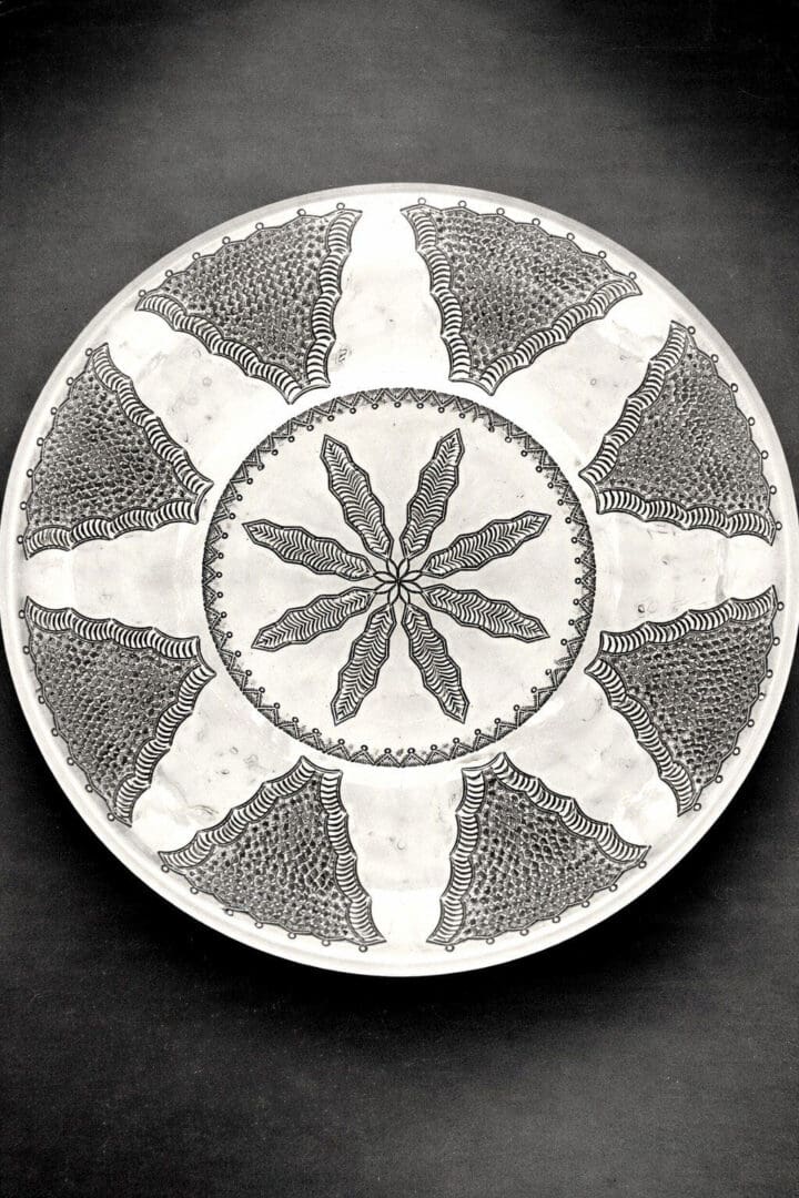 Decorative plate with intricate black patterns.