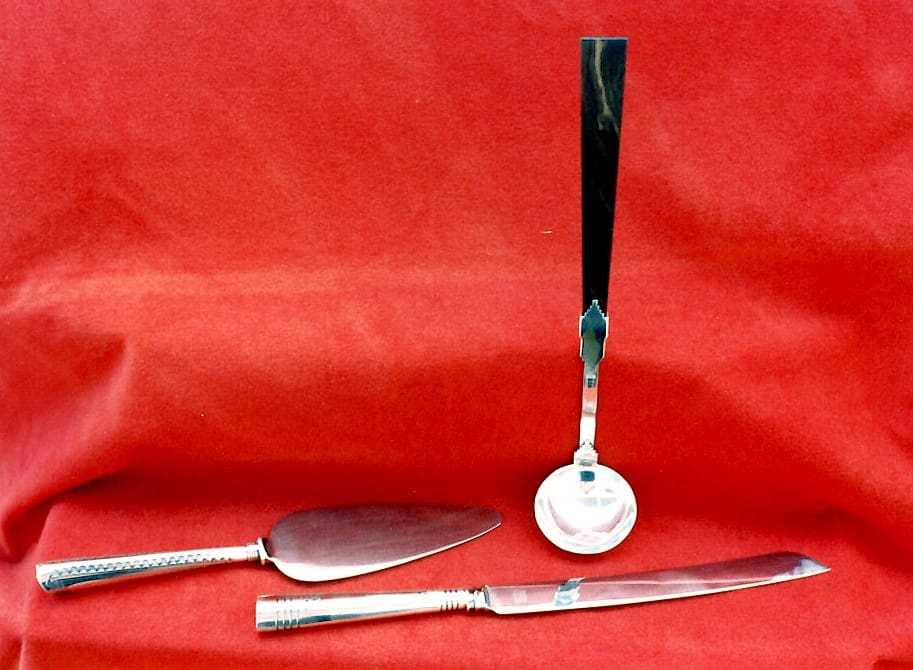 Silver utensils on a red background.