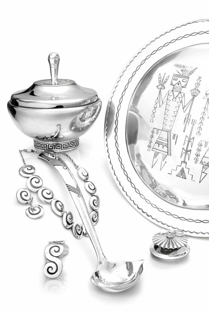 Silver ceremonial tableware with intricate designs.