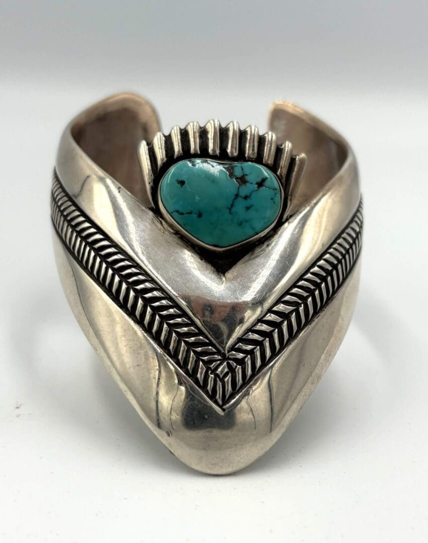 Silver cuff bracelet with turquoise stone.