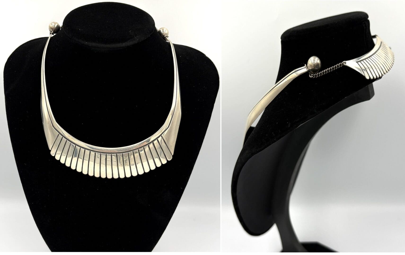 Silver necklace on black display stand.