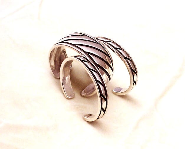 Silver rings with striped design on display.