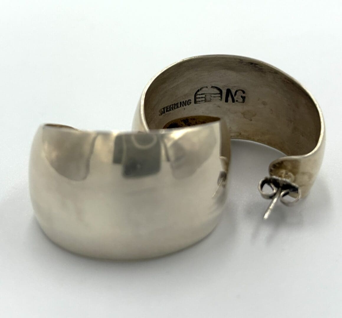 Sterling silver hoop earrings on display.