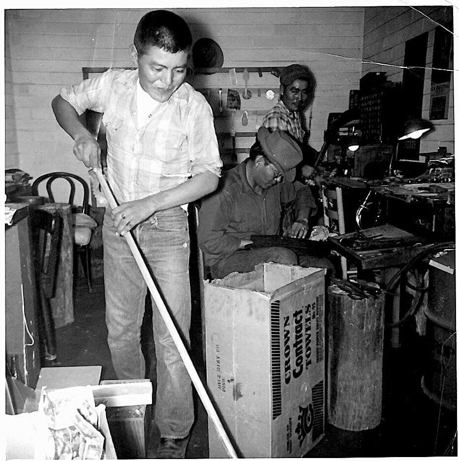 Men working in a workshop with tools.
