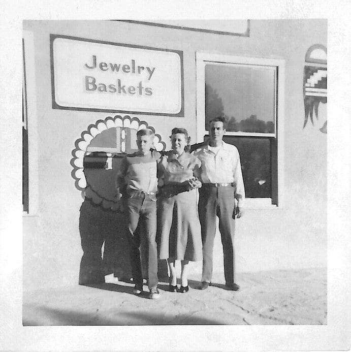 Three people standing outside jewelry store.
