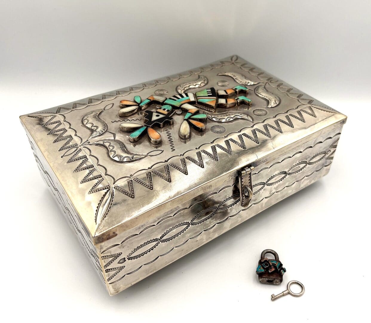 Silver decorative box with small lock and key.