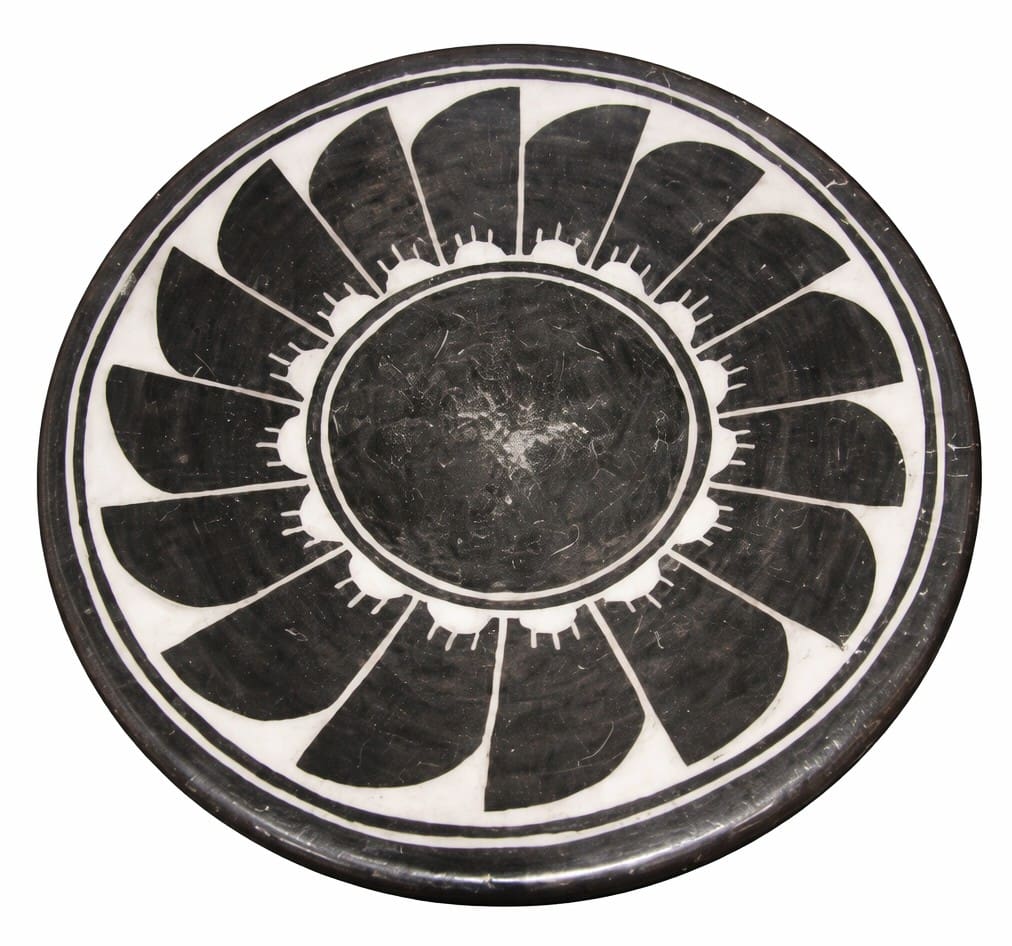 Black and white geometric patterned circular plate.