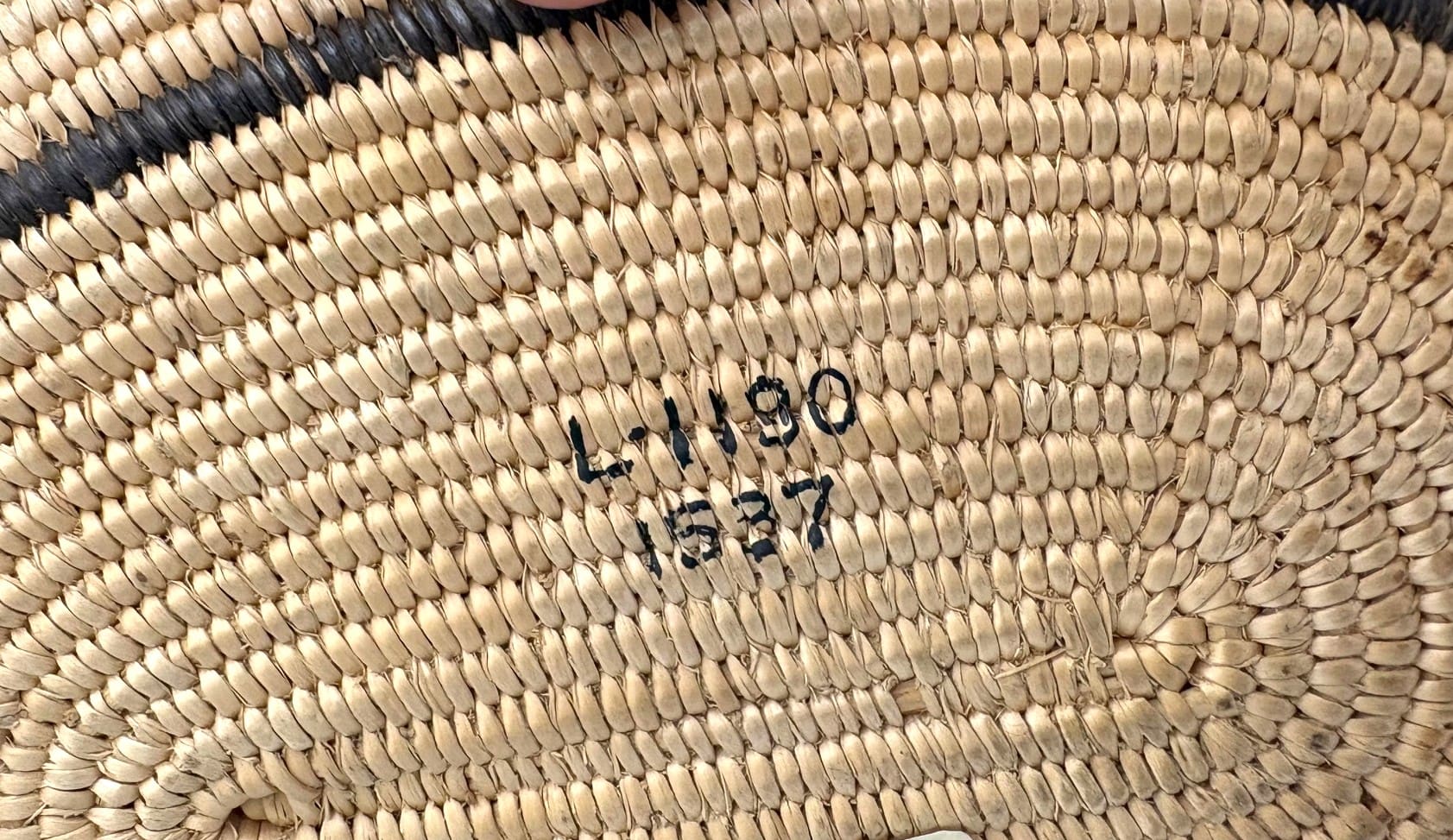 Woven basket bottom with black numbers.