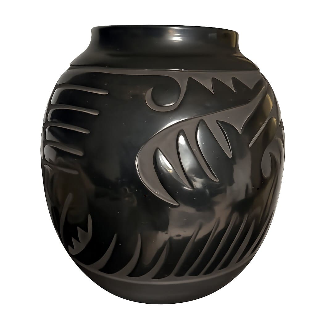 Black ceramic pot with decorative patterns.