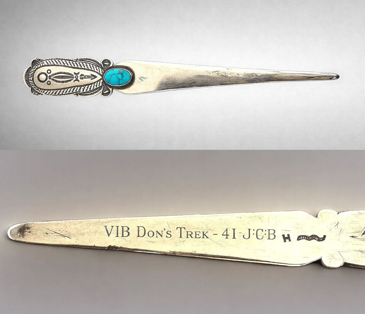 Silver letter opener with turquoise stone.