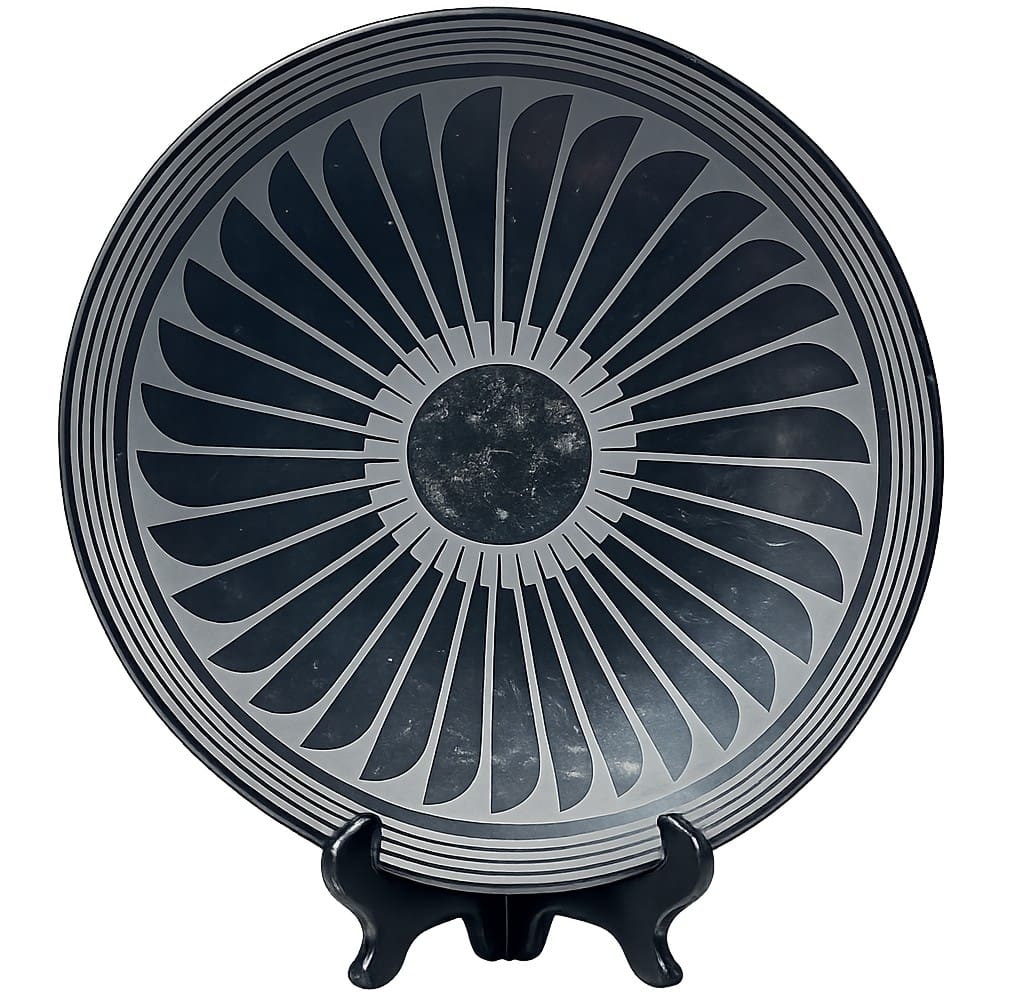 Decorative plate with geometric sunburst pattern.