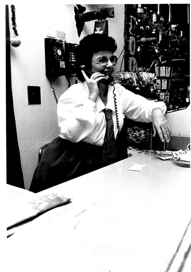 Person talking on a corded phone.