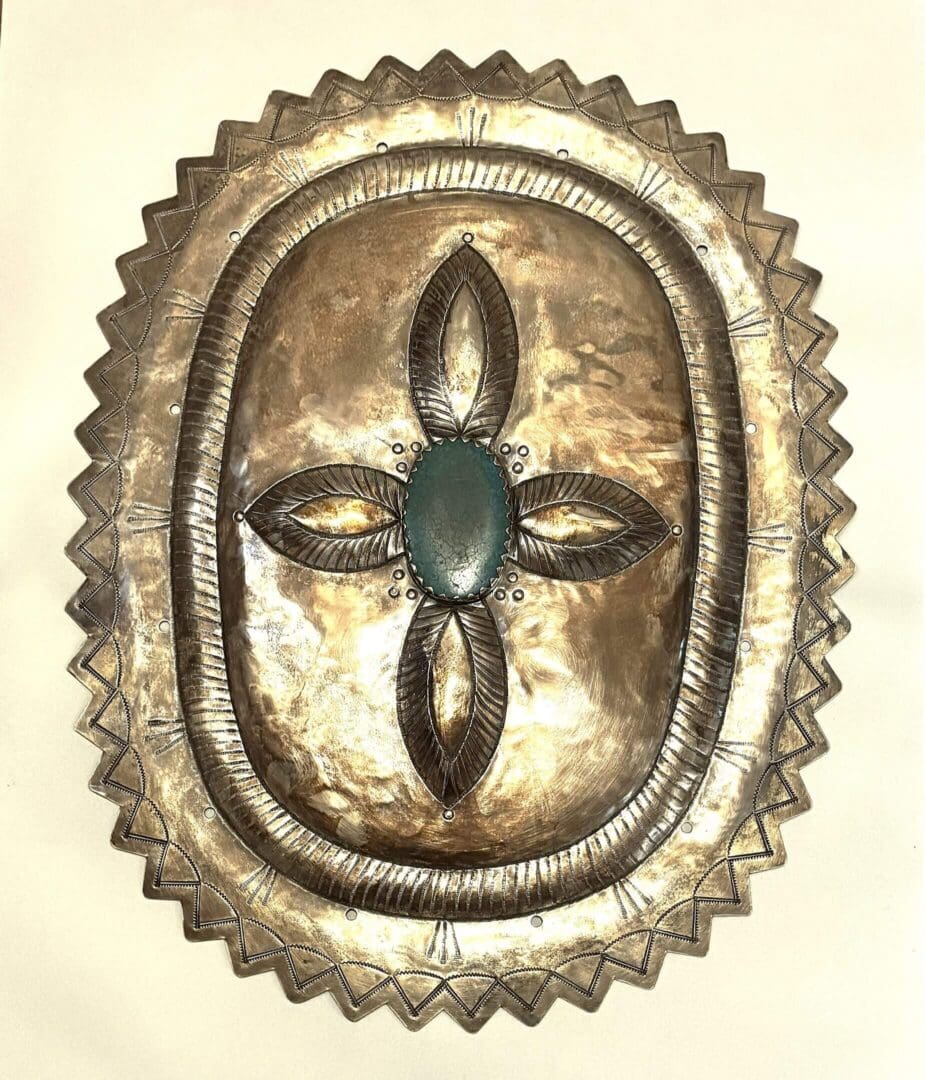 Silver belt buckle with turquoise centerpiece.