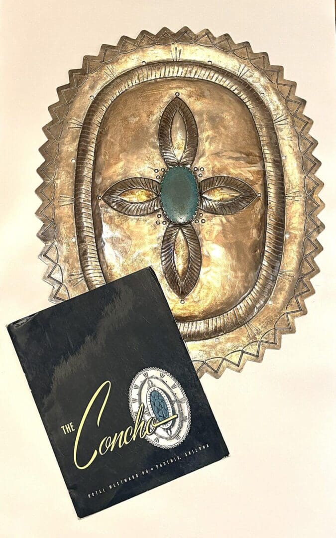 Silver decorative plate with a book cover.