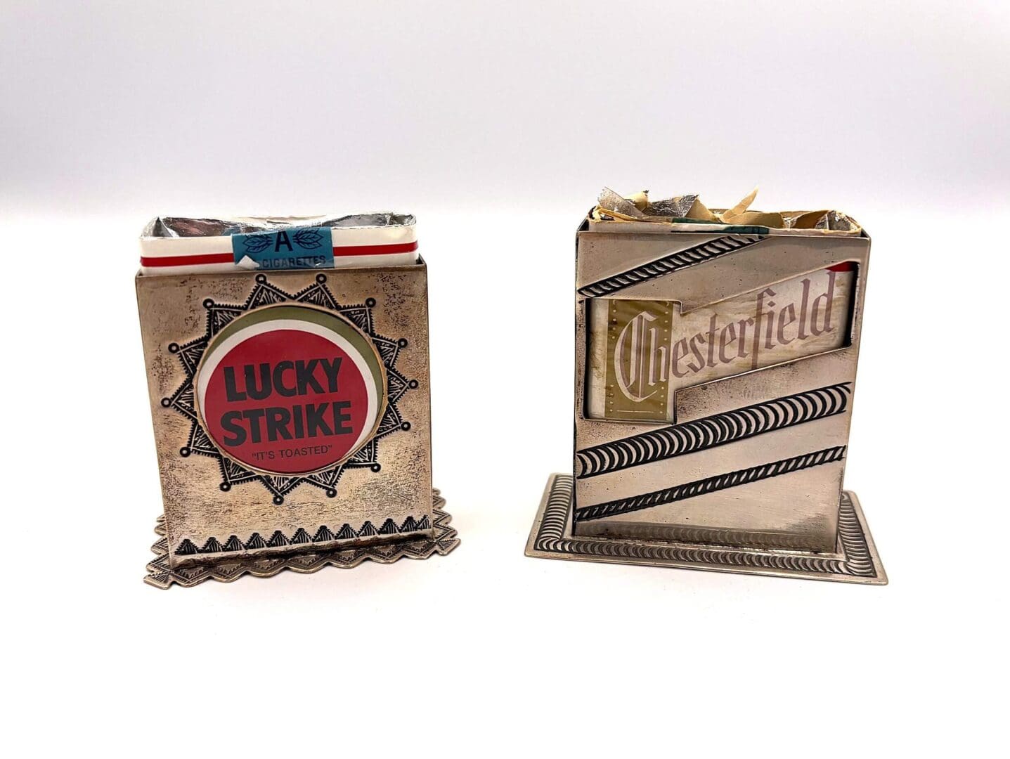 Two vintage cigarette pack holders displayed.