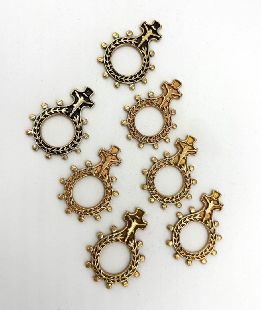 Gold and black ornate ring pendants.