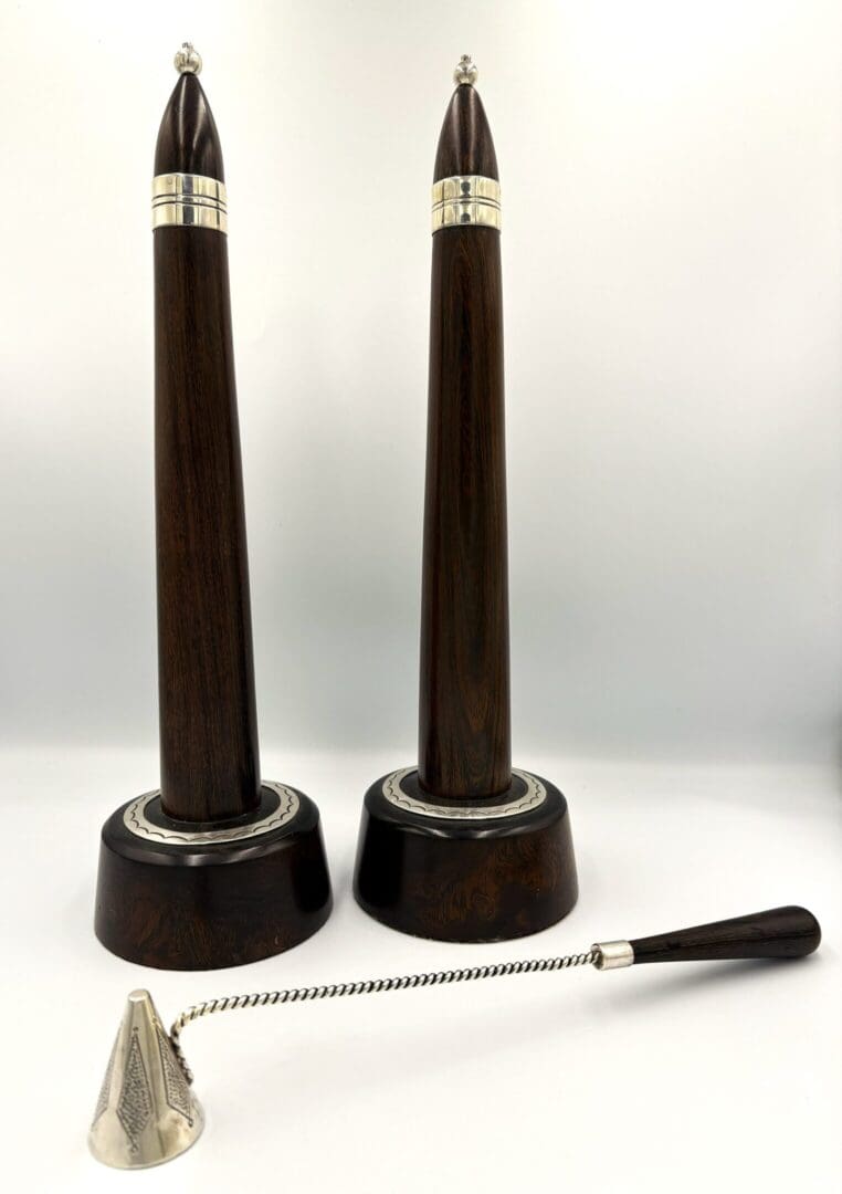 Two wooden candle holders with snuffer.