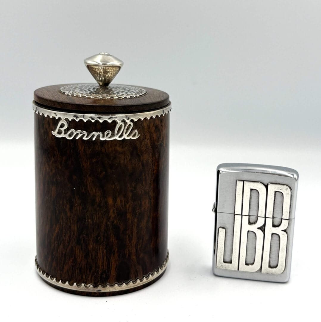 Wooden container and metal lighter with initials.