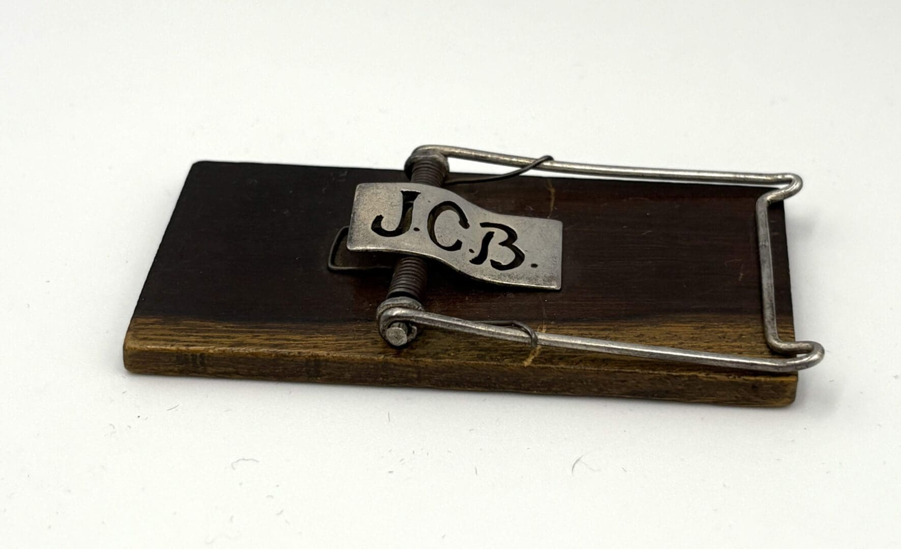 Vintage mousetrap with engraved metal plate.