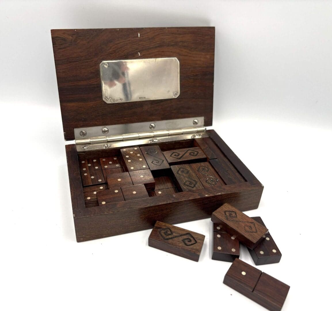 Wooden domino set in an open box.